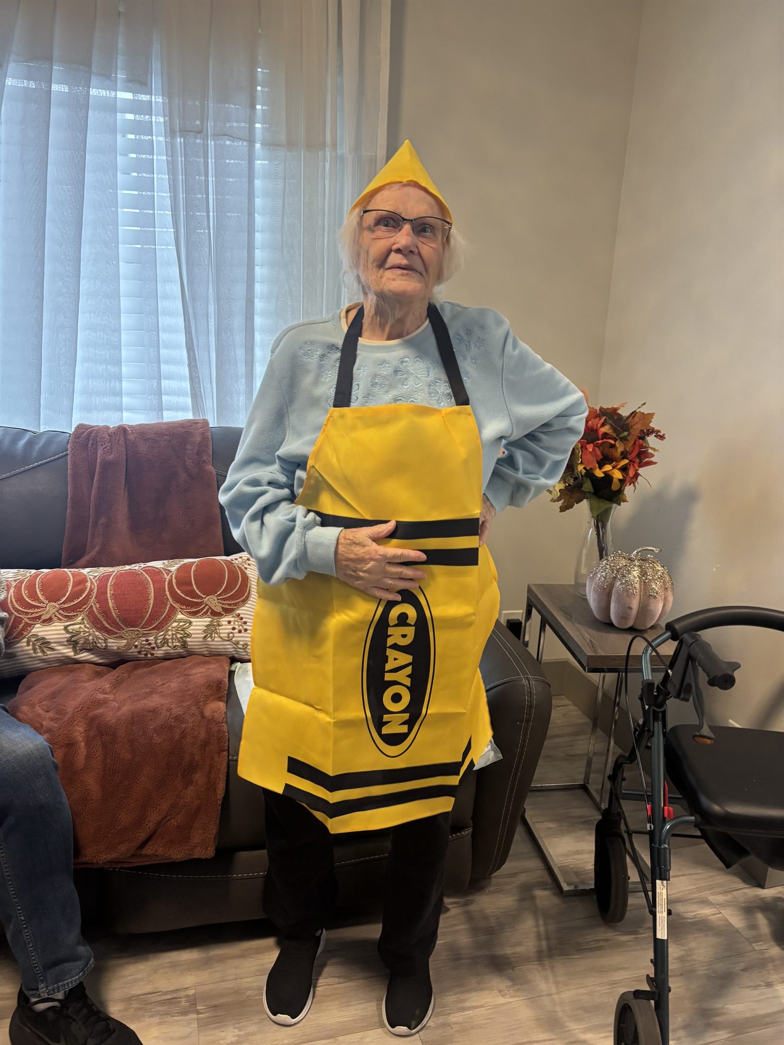 A resident dressed in a yellow crayon costume for Halloween
