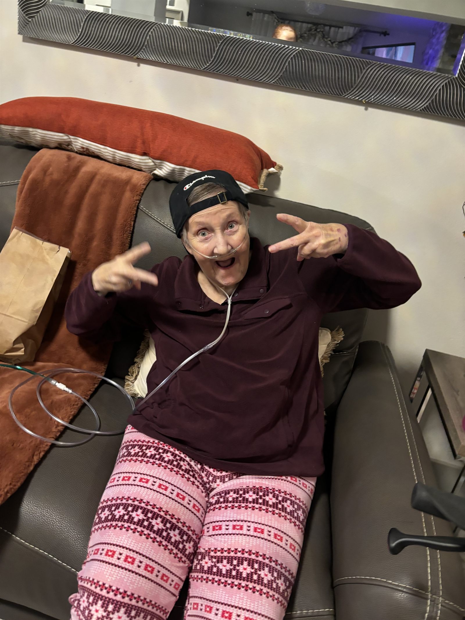 A resident wearing a backwards cap and making peace signs