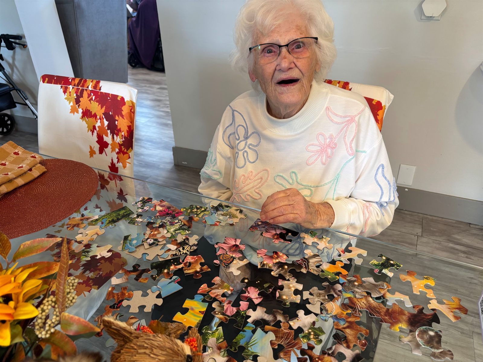 A resident working on a large autumn jigsaw puzzle