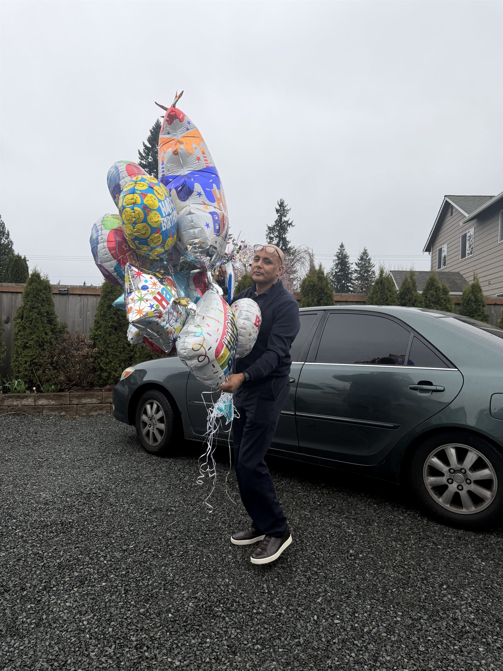Balloons being carried up the driveway before a birthday