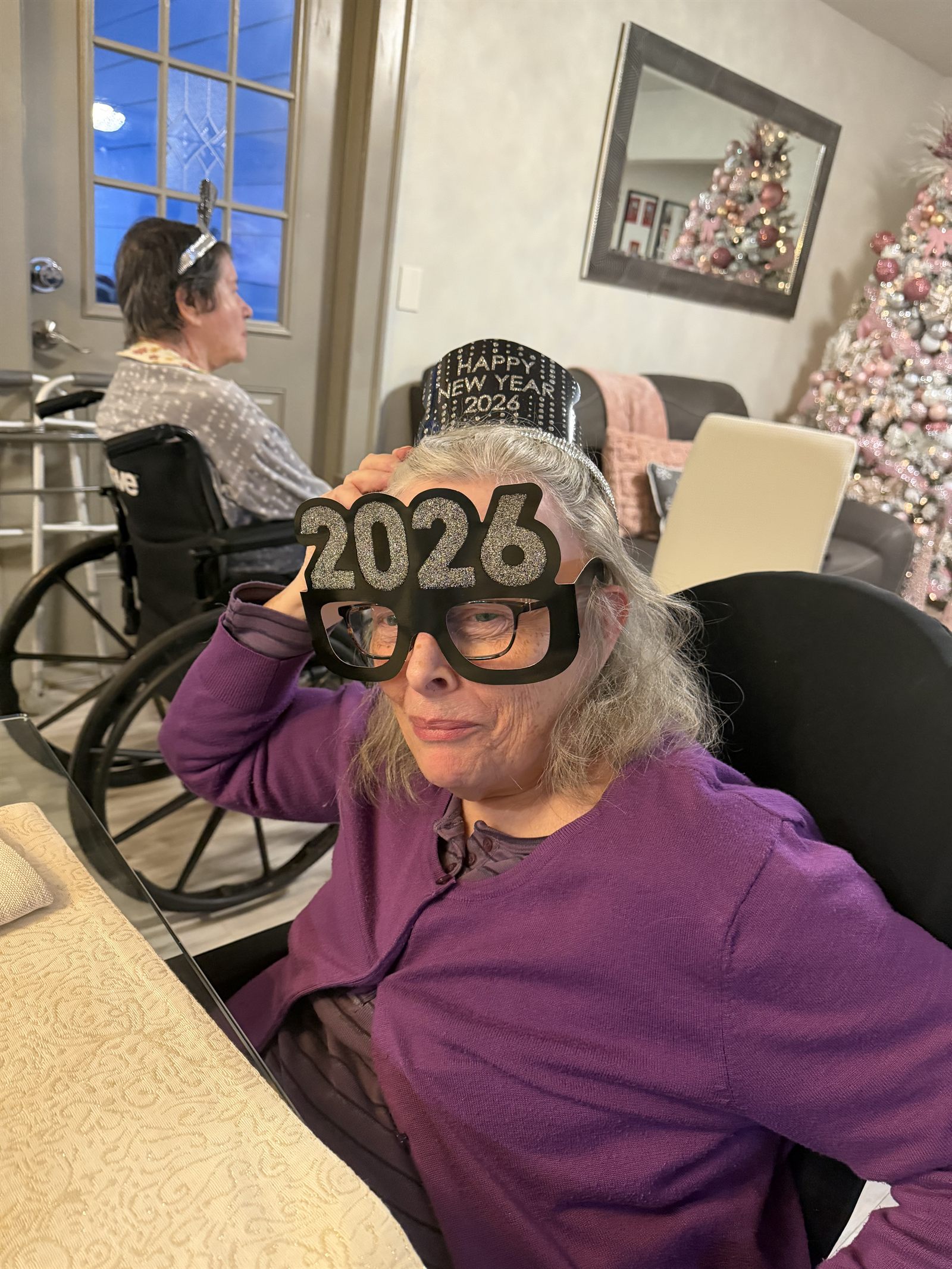 A resident wearing 2026 glasses and a New Year hat