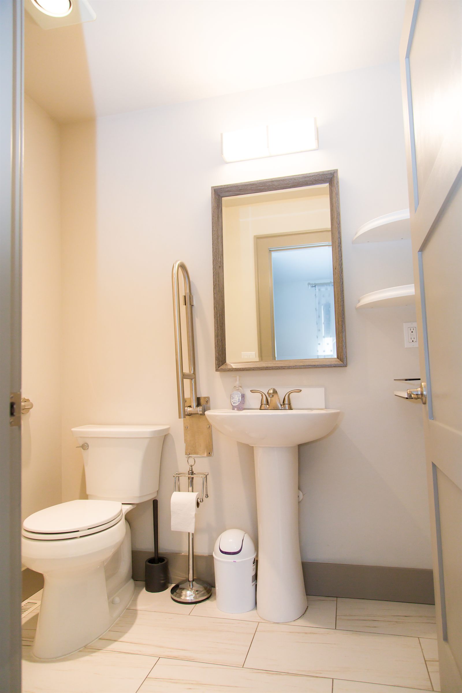Accessible bathroom with a grab rail beside the toilet