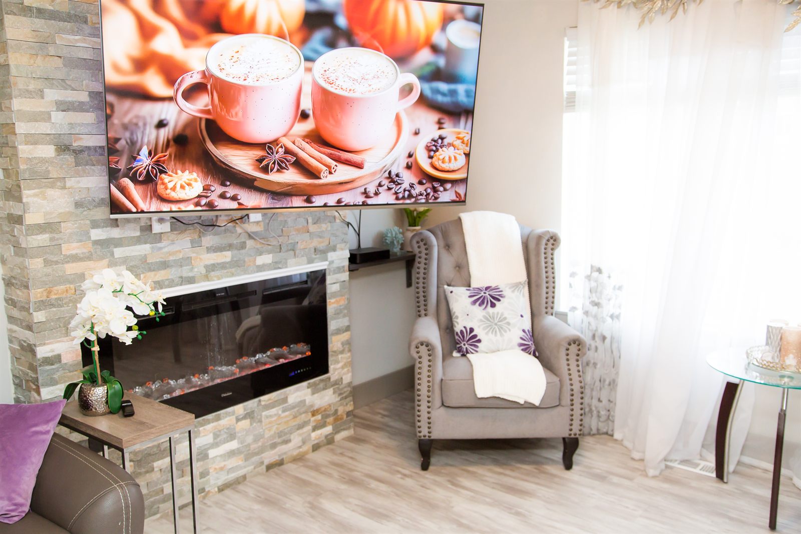 Wing-back armchair beside the fireplace with a soft throw